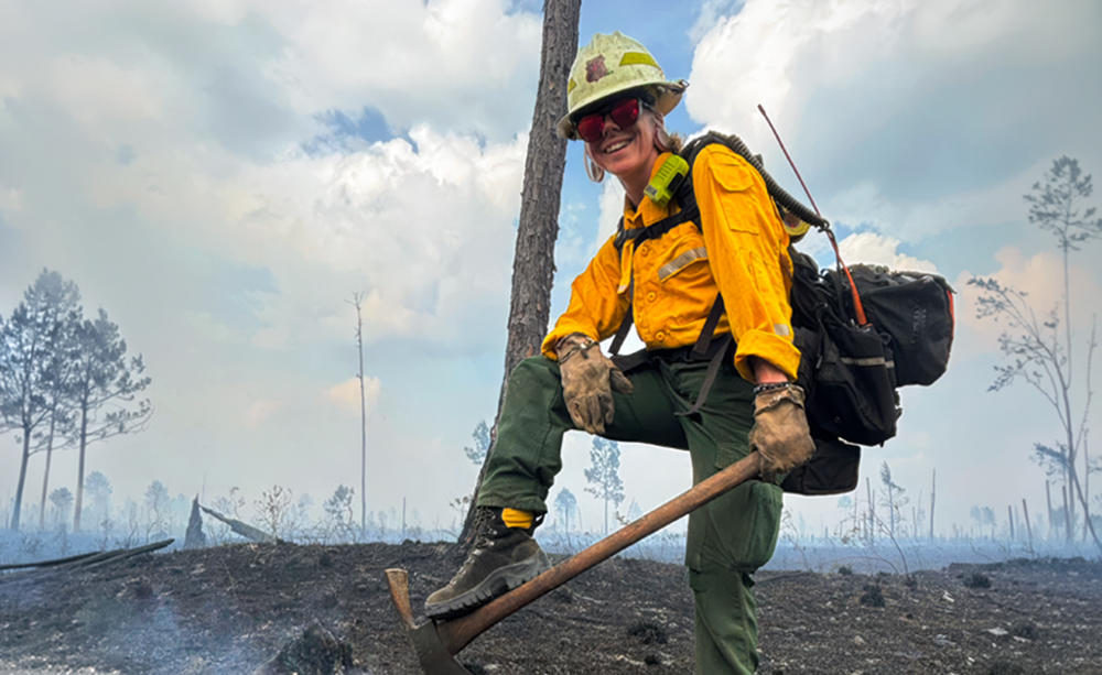 WIldland firefighter Chelsea Michael stands in her Missoula bboots