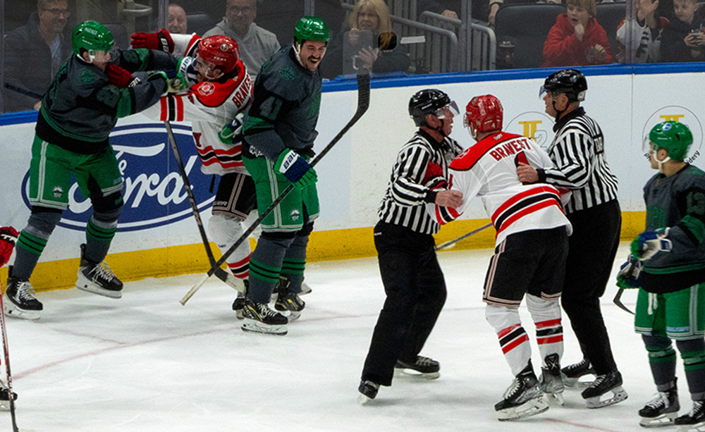 Exciting hockey action with players in intense confrontation, showcasing the thrill of the game with HAIX gear.