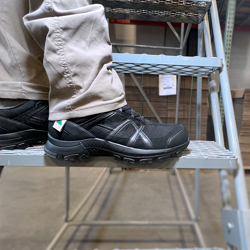 Close up of Black Eagle Safety 42.1 Low shoes worn with tan pants standing on a step ladder in a warehouse